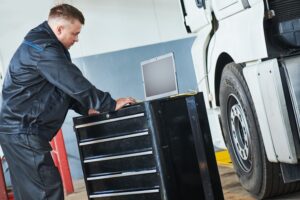 Truck repair service. Mechanic makes computer diagnostic of the semitruck