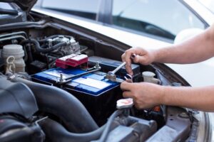 repair and installation of the battery under the hood of the car