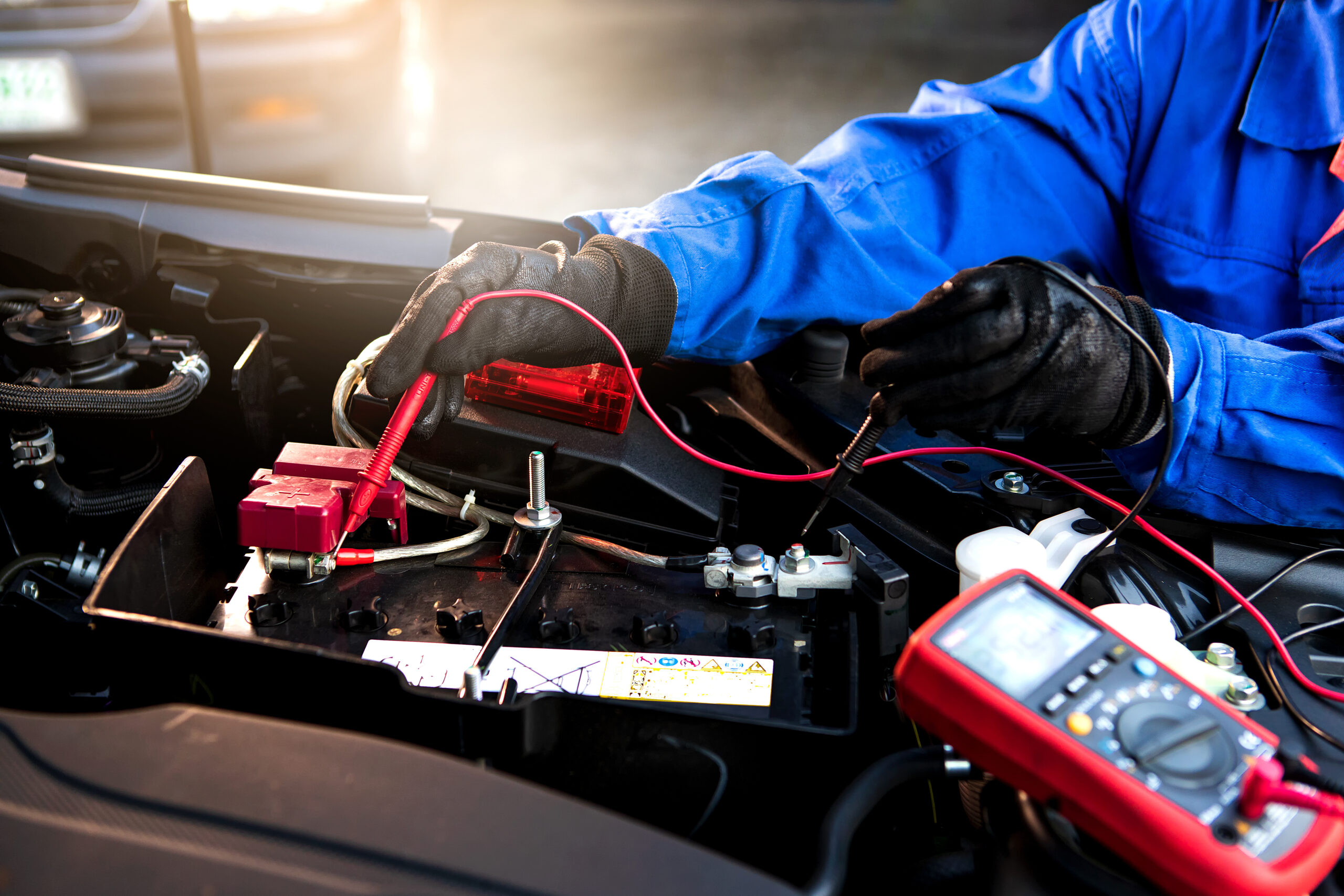 Femal technician uses multimeter voltmeter to check voltage leve