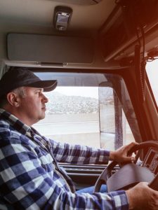 Driver in cabin of big modern truck
