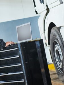 Truck repair service. Mechanic makes computer diagnostic of the semitruck