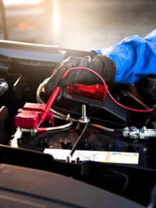 Femal technician uses multimeter voltmeter to check voltage leve