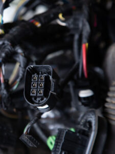 Close up of the engine control unit of the car, multicolored wir
